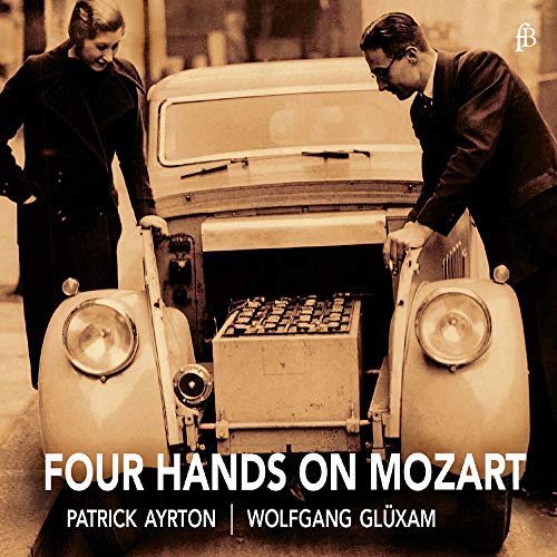 "CD cover with two men in suits beside a vintage car with piano keyboard."