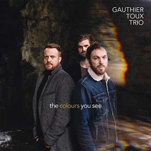 Album cover featuring three men standing in a dark, blurry background.
