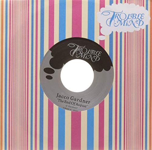 7-inch vinyl record with colorful striped sleeve and “Trouble Mind” logo.