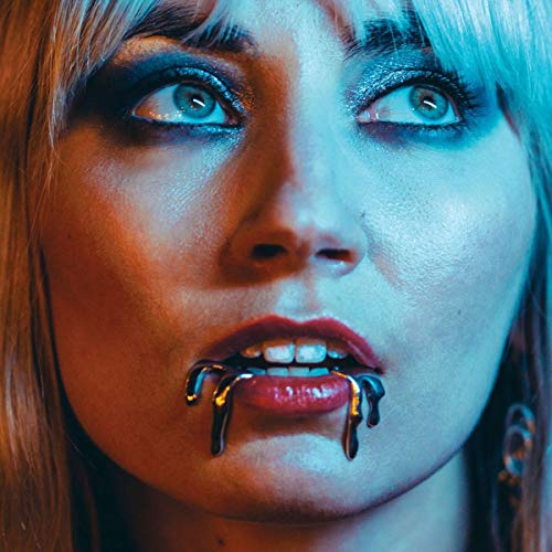 Close-up of a woman with blue eyes and black liquid on her lips.