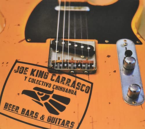 Orange electric guitar with "Joe King Carrasco" album sticker.