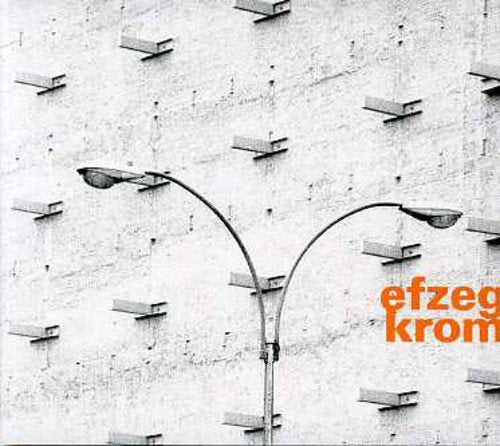 "Album cover with two street lamps against a concrete wall with protruding bricks."