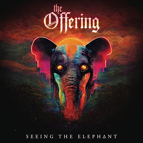 Album cover: elephant head with glowing eyes over a cityscape.