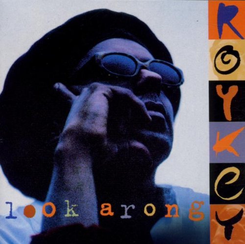 "Album cover with a man wearing sunglasses, holding a cigarette, and multicolored text."