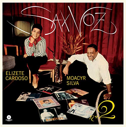 Vinyl album cover featuring a man and woman surrounded by records against a red curtain.