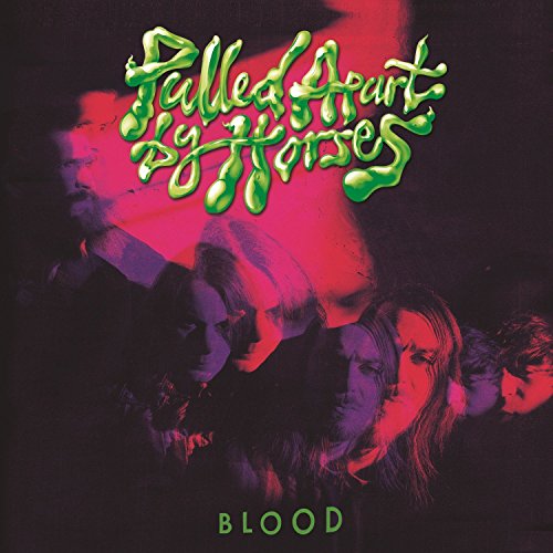 Album cover with green text and dark-toned band members' images, lit with red light.