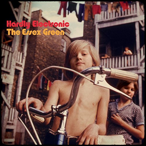 Album cover: boy with bicycle, urban backdrop, red text "Hardly Electronic".