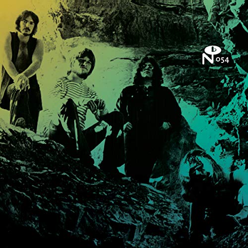 Four men posing on a rocky surface with a yellow to teal gradient overlay.