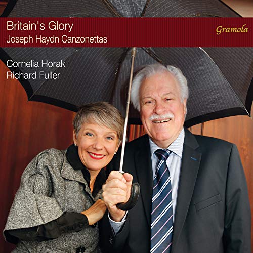 "CD cover featuring elderly man and woman under a black umbrella, formal attire."