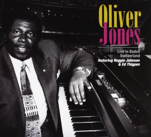 "Album cover featuring a man in a suit leaning on a piano."