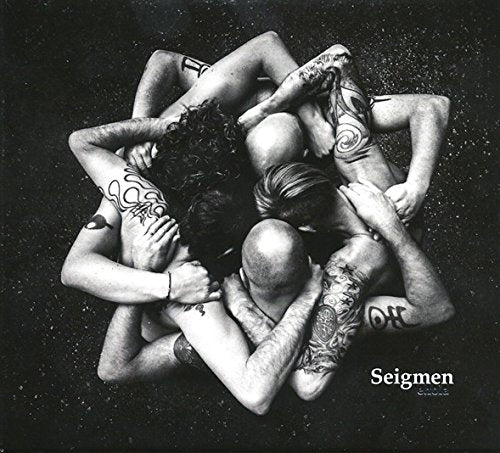Black and white image of entangled, tattooed people forming a star shape.