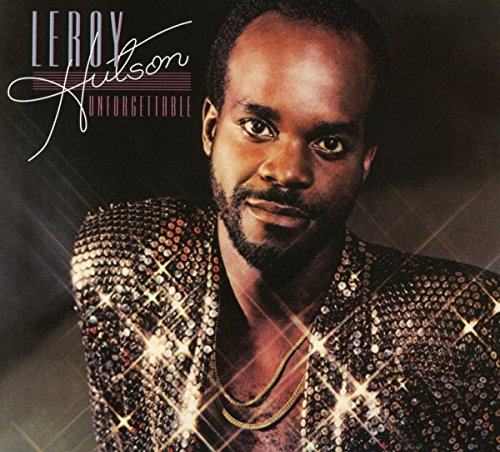 The image is a CD cover for Leroy Hutson's album "Unforgettable". The alt text for this image is: "Man in a sparkly jacket, looking directly at the camera."