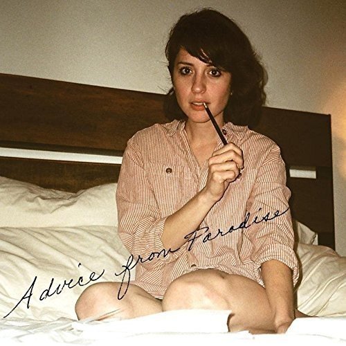 "Album cover featuring a woman sitting on a bed, holding a pen to her lips."