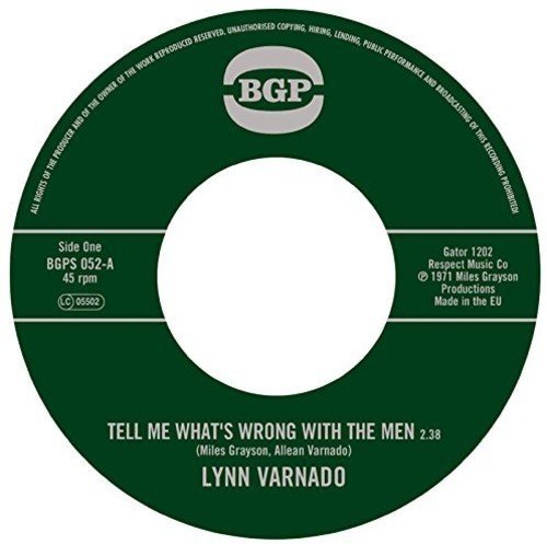 Dark green vinyl record label with white text and a central hole.