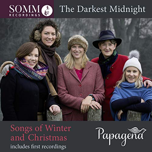 "CD cover featuring four people in winter attire standing together outdoors."