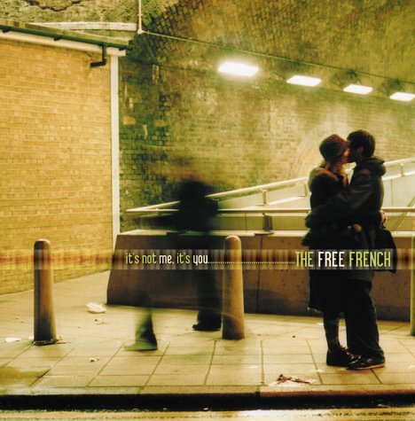 "CD cover featuring a couple kissing on a dimly lit, rainy street at night."