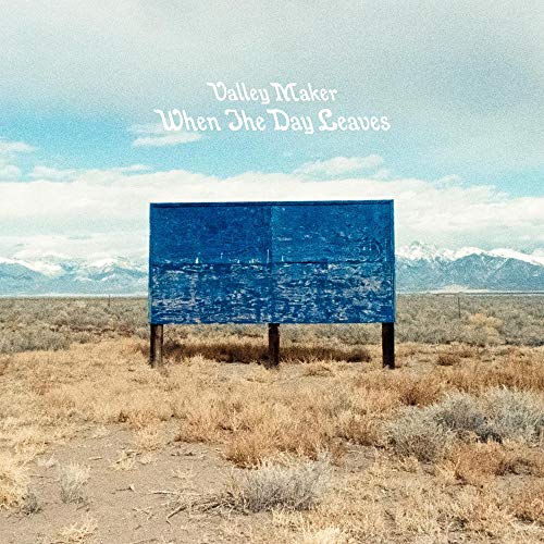 Album cover: blue billboard in a dry, mountainous landscape.