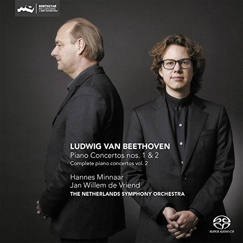 CD cover featuring two men in black suits against a dark background.