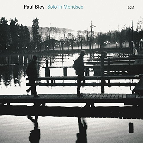 Black and white album cover with silhouetted figures on a dock by a lake.