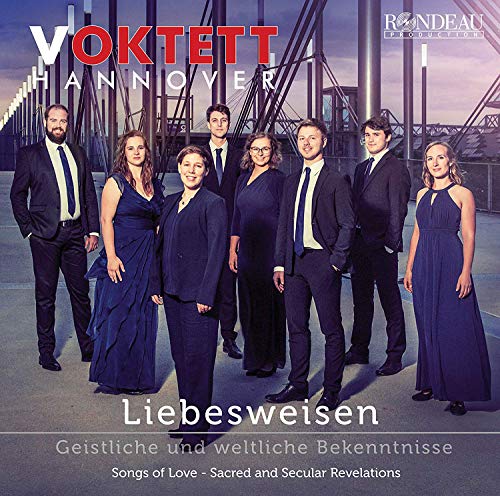 "CD cover featuring a group of 8 people in formal attire standing together."