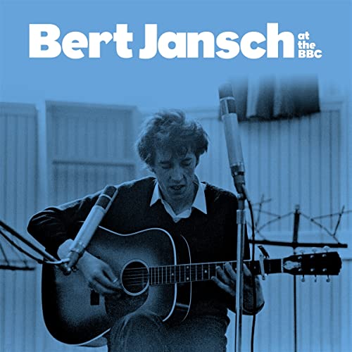 Bert Jansch playing guitar at a microphone in a studio.