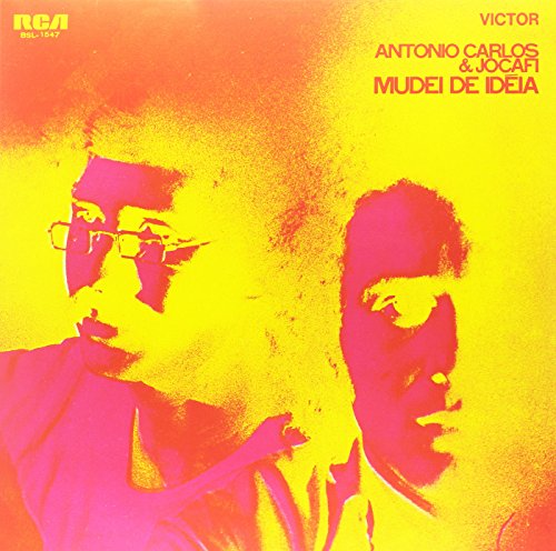 Vinyl record cover with yellow and orange background, featuring two men's portraits.