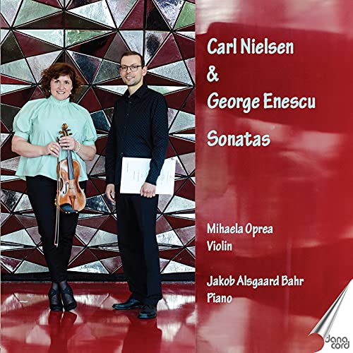 "CD cover with violinist and pianist standing in front of a geometric-patterned wall."