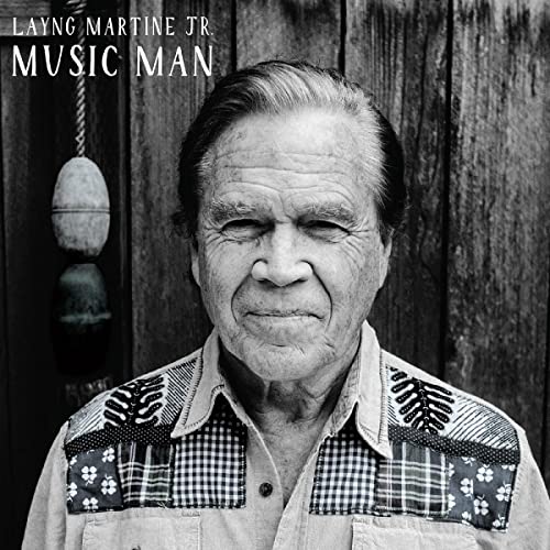 Black and white portrait of an older man with weathered skin.