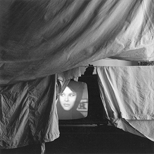 Black and white photo of a face on a vintage television.