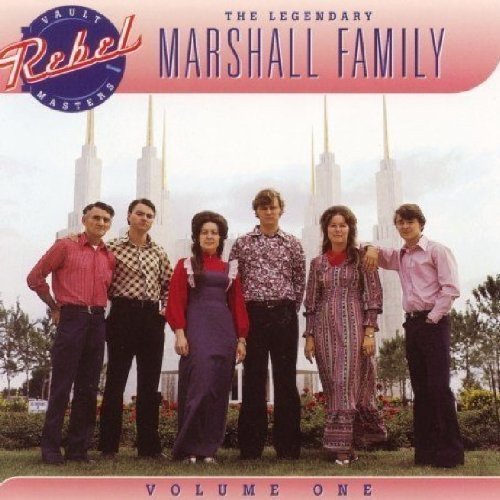 "Album cover featuring the Marshall Family standing together with a building behind them."