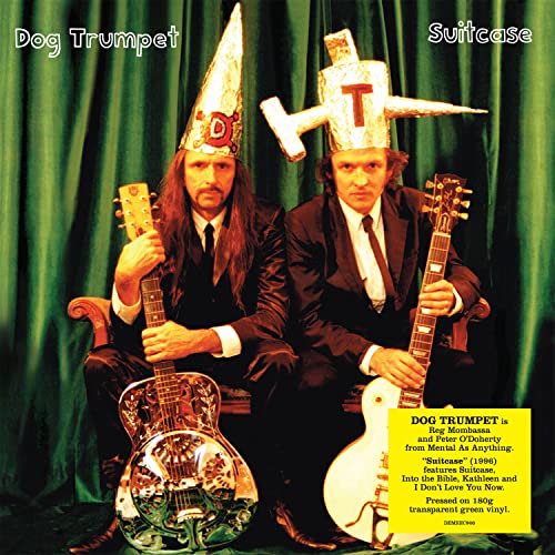 Two men in suits with unusual headwear holding guitars.