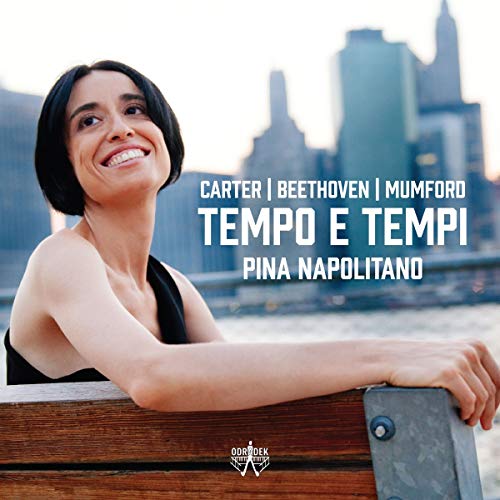 "CD cover featuring a smiling woman leaning on a wooden railing with cityscape."
