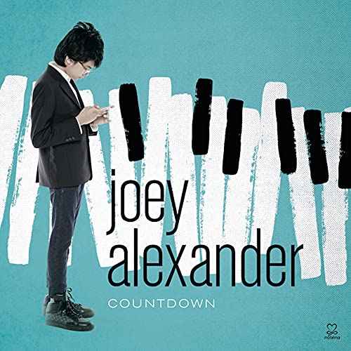 Joey Alexander album cover featuring a young man by piano keys.
