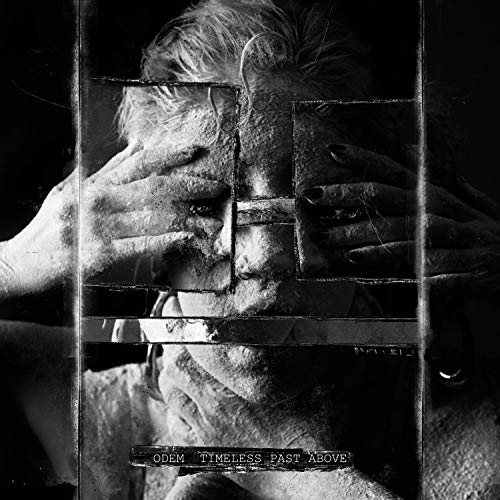 Black and white album cover featuring a fragmented face with hands covering eyes.
