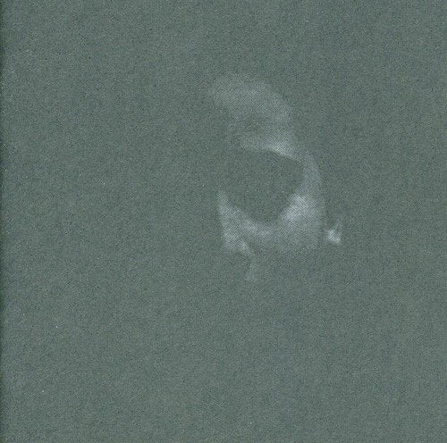 Dark green CD case with a faded, abstract face image.