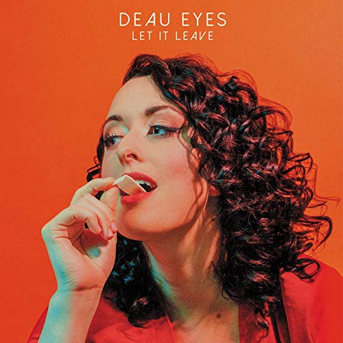 "Album cover featuring a woman with curly hair against an orange background."