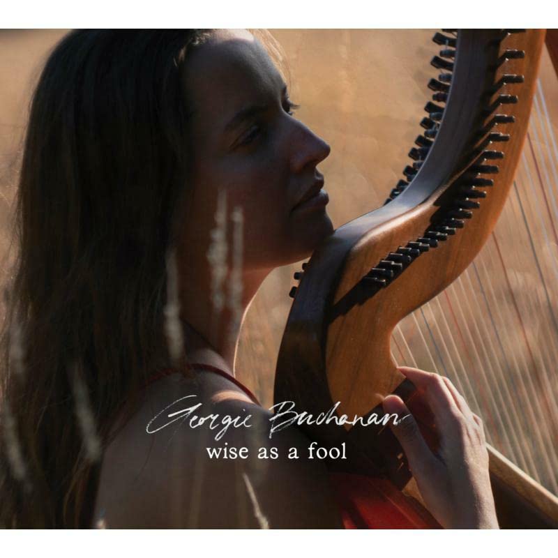 Woman with long hair playing a Celtic harp, album cover.