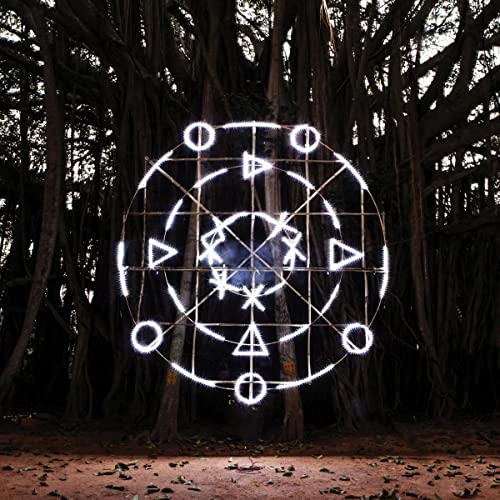 CD cover art: glowing geometric symbol in a dark forest.