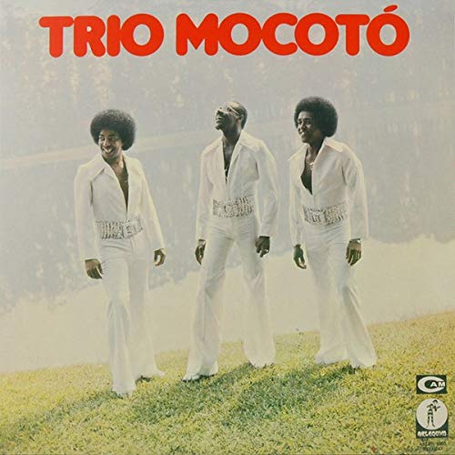 "Album cover featuring three men in white suits standing on a grassy hill."