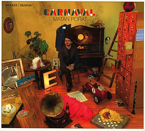 "CD cover art: man sitting by piano in cluttered room with various objects and text."