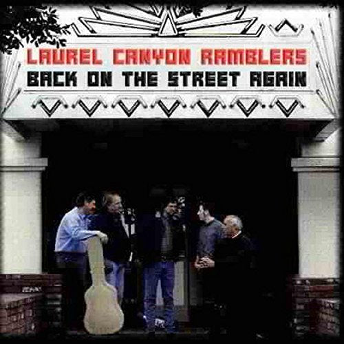 "CD cover featuring four men standing outside a building with a marquee."