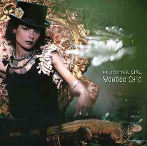 Woman in black dress and top hat sits on ornate chair with lizard, album cover artwork.
