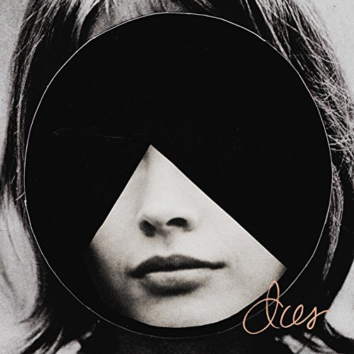 "Album cover with a black and white photo of a woman's face partially obscured."