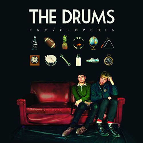 Album cover featuring two men on a red couch with various objects above them.