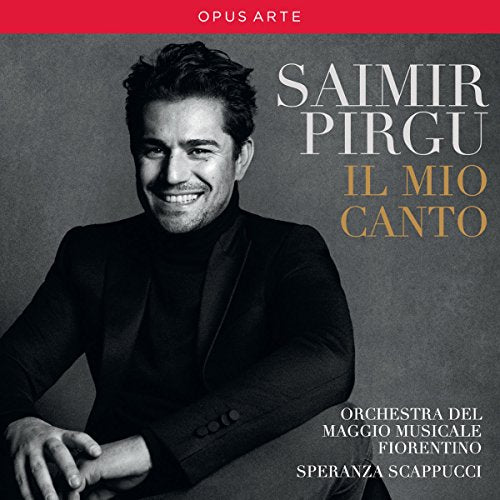 "Album cover featuring a man in a black suit against a gray background."