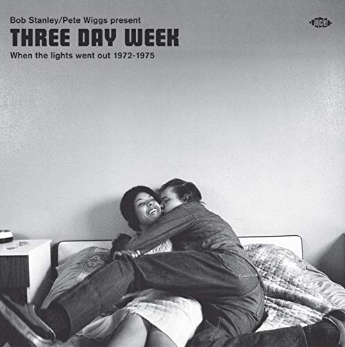 Black and white album cover depicting a couple embracing on a bed.