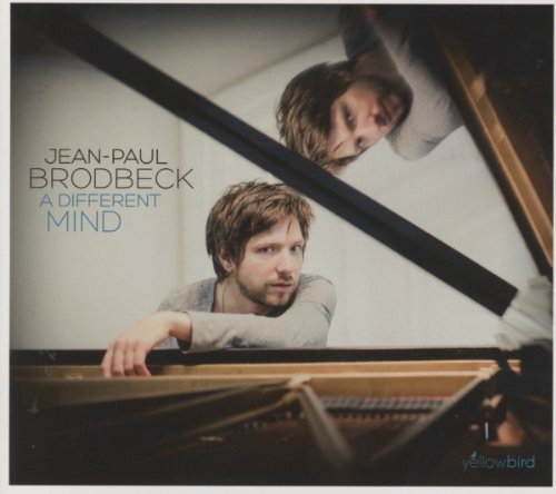 Man playing piano, reflected in mirror, on album cover with artist's name and title.