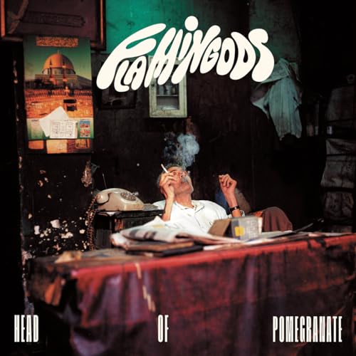CD cover: man smoking, artwork of a dome, and text “FLAMINGODS” and “POMEGRANATE”.
