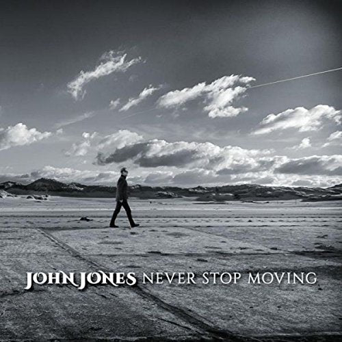 Black and white album cover with a man walking on a road.