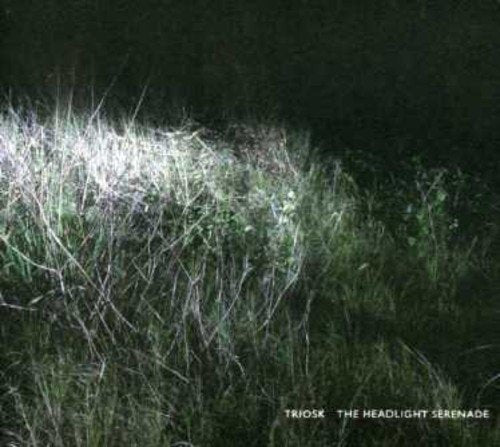 CD cover: dark grass illuminated by headlights, text at bottom.